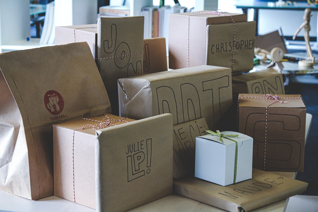 a-pile-of-brown-paper-bags-sitting-on-top-of-a-table-a6alromggtq